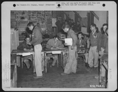 General > These Pilots, All Members Of The 449Th Fighter Group, 14Th Air Force, Have Their Records Checked At The 14Th Air Force Processing Center At Yankai, China, Prior To Returning To The United States.  They Are, Standing Left To Right: Lt. W.H. Bordner Of Cant