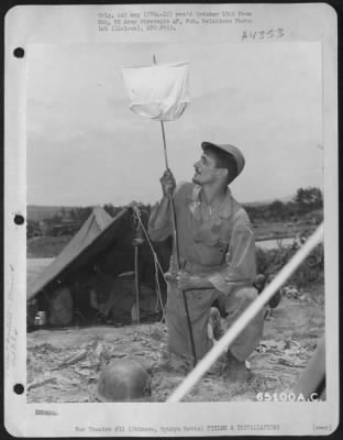 Installations > A 'Gi' Of The 41St Bomb Group Staking Out Area For New Camp On Okinawa, Ryukyu Retto.  1945.