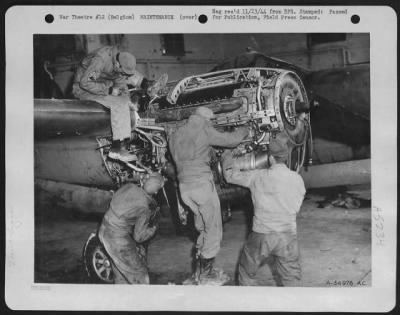 Engines > A 9th Air force P-38 Lightning fighter-bomber undergoing repairs by mechanics at a base somewhere in Belgium. Working along hours and under adverse conditions, the ground crewmen play an important part in the air offensive against Germany.