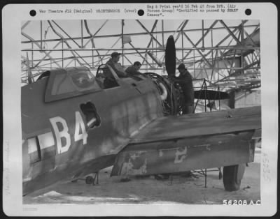 Engines > Mechanics work on a Republic P-47 Thunderbolt inside a hangar blasted by Allied heavy bombers during the Luftwaffe occupation of the field. This is the seventh field used by the 365th Fighter-bomber group since June 28, 1944, the day advance elements
