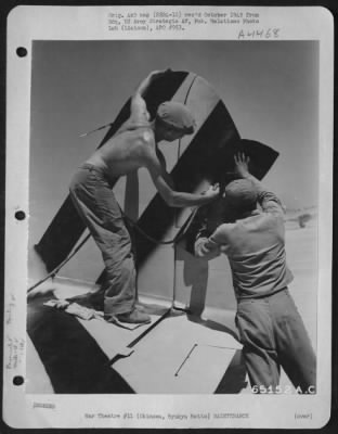 Thumbnail for Painting & Washing > Cpl Eldon E. Haek, 333 States Street, Sedro Woolley, Washington, A Painter For The 18Th Fighter Squadron, 318Th Fighter Group, Sprays New Black And Yellow Tail Identification Colors On The Planes Of His Squadron.  The New Color Scheme, Being Adopted Throu