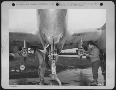 Thumbnail for General > Two 9th Air force combat cameraman adjust 35mm motion picture cameras on the wings of a Lockheed P-38 Lightning fighter-bomber at a base in Belgium. The cameras, specially constructed for the purpose, are used to obtain film ofotage