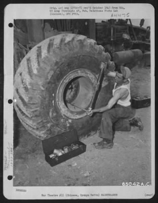 Thumbnail for Tires & Wheels > T/5 Gerald Reinhart, Heavy Equipment Mechanic With The 1878Th Engineer Aviaition Battalion, Checks The Tightness Of Lug-Bolts On The Huge 5 Foot Tire And Wheel On A Tournapull.  Okinawa, Ryukyu Retto.