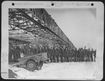 Thumbnail for General > Enlisted men of the 365th Fighter-bomber group ofrm a mess line under the battered remains of a hangar at this ofrmer Luftwaffe base in Belgium.