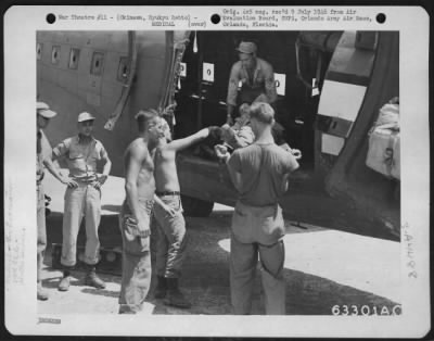 Thumbnail for Evacuation > Okinawa, Ryukyu Retto - Litter Patients Being Unloaded From A Douglas C-47 Of The 316Th Troop Carrier Group.  These Planes Were Shuttle-Running From Ie Shima, Yonton Strip.  27 July 1945.