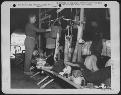 Thumbnail for Hospital Patients > Personnel Assigned To The American Military Government Medical Unit Check The Condition Of Patients In The Traction Ward At The Hospital On Okinawa, Ryukyu Retto.  All The Patients Are Natives Of The Island.  15 June 1945.