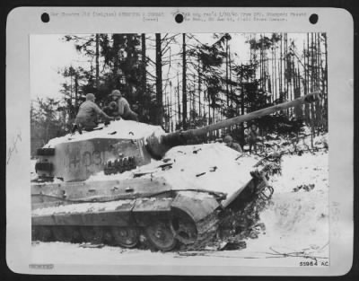 General > Ninth Air force fighter-bombers in co-operation with ground artillery knocked out this Royal Tiger tank on the main road from Bastogne to Houffalize during recent fighting in the Belgian Bulge. The condition of trees in the background provides an