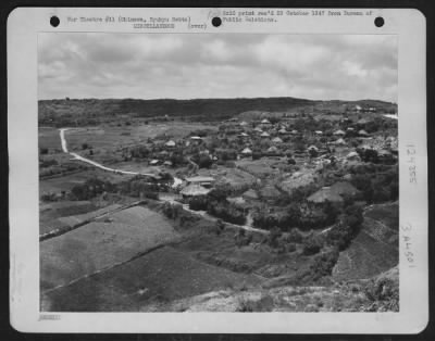 Thumbnail for General > Shuri City -- Seen From A Hillside - This Is A Good View Of Part Of Shuri City, Once The Capital Of Okinawa, Ryukyu Retto And Now A Modern Progressive Village Trying To Recoup From The Recent War.  The Picture Shows The Familar Thatched Roof Huts, A Windi