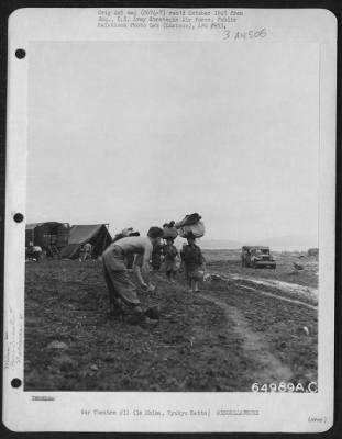 Thumbnail for General > Pfc. Paul Kervern Of 128 Bergen Avenue, Brooklyn, New York, Interrupts His Shampoo To Watch A Group Of Native Women Carrying Bundles On Their Heads.  Ie Shima, Ryukyu Retto, 3 May 1945.