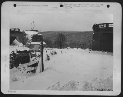 General > Fighter-bombers of the 9th AF collapsed this railroad bridge east of St. Vith, Belgium to deprive the withdrawing Germans of an "escape" route.