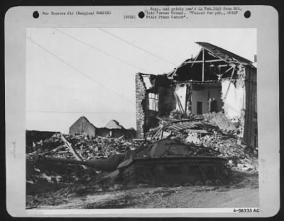 General > The intensity of a recent 9th AF fighter-bomber attack which knocked out this German Tiger tank east of Luxembourg, Belgium is indicated by the demolished wall of the building in the background and the surrounding rubble. Pilots of the three TAC