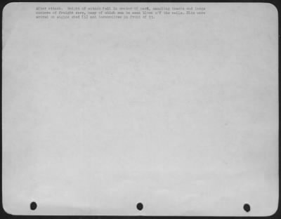 General > After attack. Weight of attack fell in center of yard, mangling tracks and large numbers of freight cars, many of which can be seen blown off the rails. Hits were scored on engine shed (1) and locomotives in front of it.