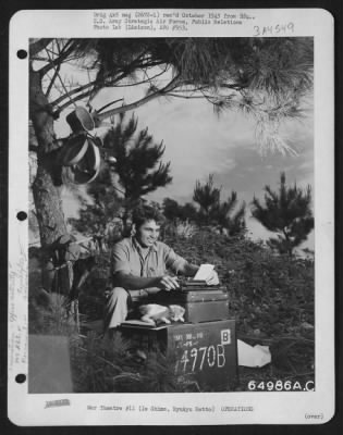 Thumbnail for General > 'Rum And Coke', A Feline Veteran Of Saipan, And One Of The Mascots Of The 364Th Air Service Group, Proves A Playful Paper Weight As 1St Sgt. John Pavesick Of Mcdonald, Ohio, Types His Morning Report At An Improvised Desk In The Shade Of A Tree On Ie Shima