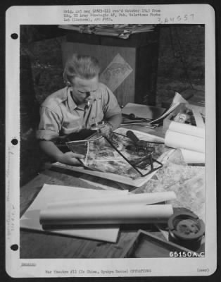 General > Photo Interpreter Studies Aerial Photographs Of Target Area; He Is Working In The Group Intelligence Office Of The 318Th Fighter Group On Ie Shima, Ryukyu Retto.