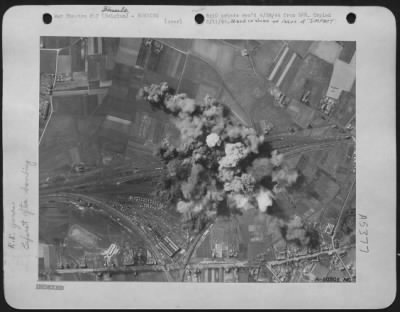 Hasselt > The first formation of 9th AF B-26 Marauder medium bombers attacking the important Hasselt railway marshalling yards in Nazi Occupied Belgium the day before Easter put its bomb concentration squarely on the target. The white smoke shooting skyward