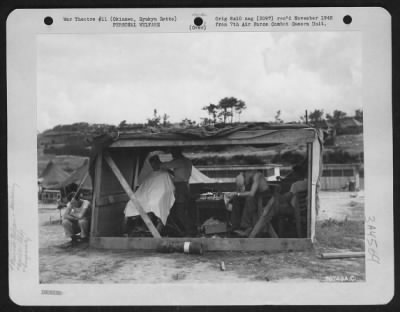 General > 7Th Air Force Personnel Take Advantage Of Their Free Time To Have Their Hair Trimmed In A Make-Shift Barber Shop In The 7Th Air Force Headquarters Area On Okinawa, Ryukyu Retto.  15 August 1945.