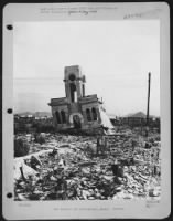 One Year After The Dropping Of The First Atom Bomb, Hiroshima, Japan, Is Still A Town Of Rubble And Debris.  This Steel Frame Building (The Shimomuna Watch Shop) Had Its First Story Columns Buckle Away From The Terrific Forces Of The Blast, Dropping The S - Page 1