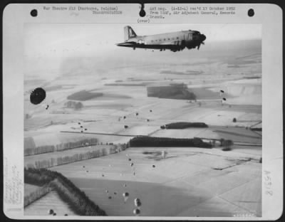 General > A Douglas C-47 Of The 9Th Troop Carrier Command Drop Supplies Over Bastogne, Belgium.  23 Dec. 1944.