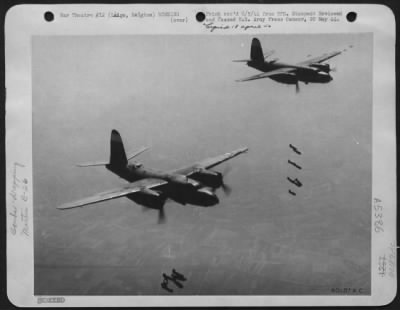 Liege > Two Martin B-26 Marauder Bombers Of The Ninth Air Force, Drop Their Bombs On A Railroad Bridge Target, 10 Miles From The German Border At Liege, Belgium.  Observers Saw Large Explosions In The Target Area Indicating That Fuel Storage Tanks May Also Have B