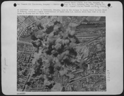 Debreczen > An important rail center in Debreczen, Hungary, used by the Germans to supply their Eastern front in Rumania, receives a heavy concentration of bombs from U.S. Bombers which then flew on to new bases in Russia for the first time.