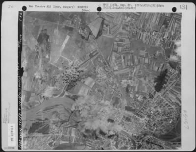 Gyor > Bomb bursts cover the target area after planes of the 2nd Bomb Group, 96th Bomb Squadron dropped their lethal missiles on the Aircraft Factory at Gyor, Hungary, 9 August 1944.