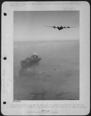 Petfurdo > Consolidated B-24s of the 15th AF swing into the attack on the Petfurdo oil plant in Hungary on 14 June 44-Flying over billowing smoke from fires set by preceding bombers.