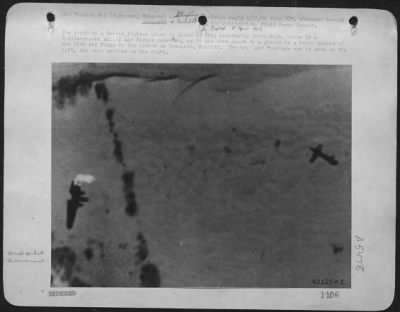 General > The Death Of A German Fighter Plane Is Shown In This Remarkable Photograph, Taken By A Mediterranean Allied Air Forces Cameraman, As It Was Shot Apart By A Gunner In A Heavy Bomber Of The 15Th Air Force In The Attack On Budapest, Hungary.  The Tail And Fu