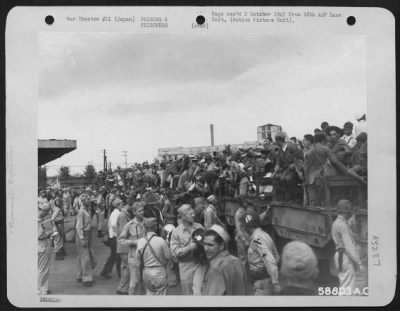 Thumbnail for General > Released Prisoners Of War Climbing On Trucks At Yokohama Station, Japan, To Go To Dock Area And Aboard Hospital Ship.  September 1945.