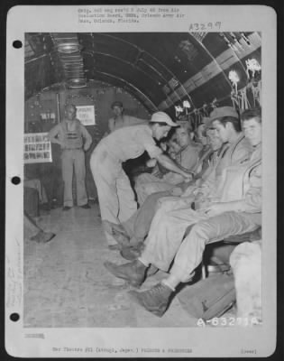 Thumbnail for General > Crew Chief 'Checks' The Safety Belts Of Prisoners' Of War Just Prior To Take-Off.  Atsugi, Japan, 8 September 1945.