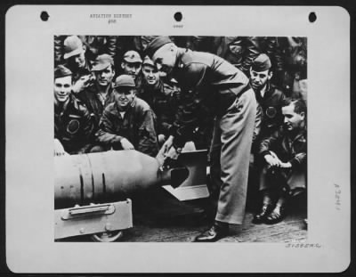 General > Maj. Gen. (Lt. Col. Then) James H. (Jimmy) Doolittle, U.S.A. wires a Japanese medal to the fin of a 500 lb. bomb which shortly thereafter was returned to its Nipponese makers in a blast of destruction. The ceremony took place on the deck