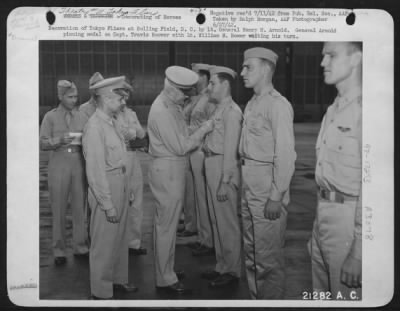Ceremonies & Decorations > Decoration of Tokyo Fliers at Bolling Field, D.C. by Lt. General Henry H. Arnold. General Arnold pinning medal on Capt. Travis Hoover with Lt. William M. Bower waiting his turn.