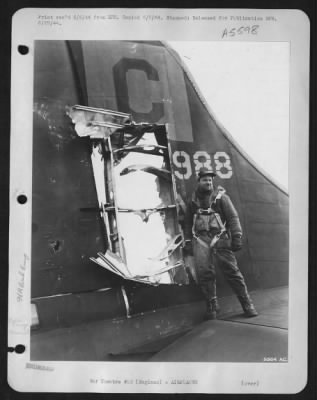 Battle Damage > S/Sgt. Charles A. Haywood, 27, Weatherofrd, Okla., tail gunner on the U.S. Army 8th Air force Boeing B-17 Flying ofrtress "Lace's Aces", stands beside the 3 by 6 ft. hole torn in the tail of his ship by 20 mm shells that barely missed his head