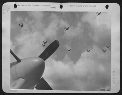 Boeing > Boeing B-17 Flying ofrtresses lumber over North American P-51 Mustang base in England, past the nose of an 8th Fighter Command fighter plane which has just returned from escorting another formation of heavies blasting at the front line area in