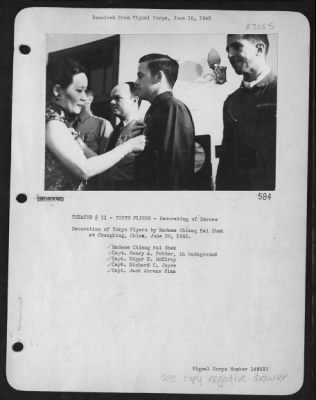 Thumbnail for Ceremonies & Decorations > Decoration Of Tokyo Flyers By Madame Chiang Kai Shek At Chungking, China, June 29, 1942. Madame Chiang Kai Shek.  Capt. Henery A. Potter, In Background,  Capt. Edgar E. Mcelroy, Capt. Richard O. Joyce, Capt. Jack Ahren Sims.