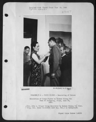 Ceremonies & Decorations > Decoration Of Tokyo Flyers By Madame Chiang Kai Shek At Chungking, China, June 29, 1942. Colonel John A. Hilger Being Decorated By Madame Chiang Kai Shek. Brig Gen. James Doolittle (Now Major General) In Background.