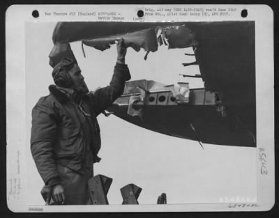 Battle Damage > Lt. W.G. Mckenny Examines Hole In The Wing Of His Boeing B-17 "Flying Fortress" Of The 401St Bomb Group, England, 19 March 1945.