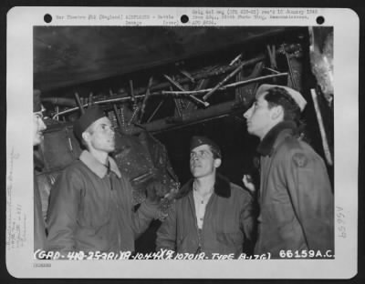 Battle Damage > Crew Members Look At Their Damaged Boeing B-17 "Flying Fortress" Of The 381St Bomb Group, England, 8 October 1944.  (Aircraft No. 107018).