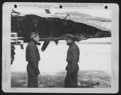 Battle Damage > Men Of The 379Th Bomb Group Examine The Wing Of A Boeing B-17 (A/C No. 633) Which Was Damaged During A Mission Over Enemy Territory On 29 January 1945.  England.