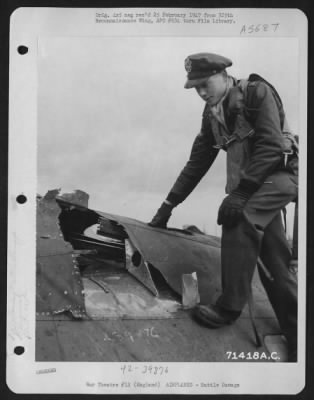 Battle Damage > Lt. Flottrop, Of The 390Th Bomb Group, Examines The Damage Done To His Boeing B-17 "Flying Fortress" While On A Mission Over Enemy Territory.  8Th Air Force Base, England, 11 March 1944.