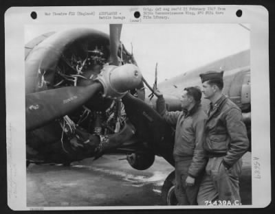 Thumbnail for Battle Damage > Two Crew Members Of The 390Th Bomb Group Examine The Engine Of Their Boeing B-17 "Flying Fortress" Which Was Damaged In A Raid Over Berlin, Germany, 8Th Air Force Base, England.  7 May 1944.