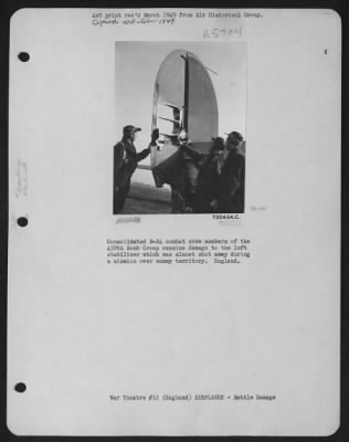 Battle Damage > Consolidated B-24 Combat Crew Members Of The 458Th Bomb Group Examine Damage To The Left Stabilizer Which Was Almost Shot Away During A Mission Over Enemy Territory.  England.