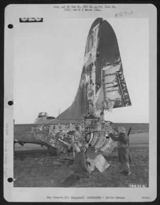 Battle Damage > Field Guards Inspect The Damaged Tail Of A Boeing B-17 Which Was Hit By An Anti-Aircraft Shell During A Mission Over Dieppe.  England, 27 January 1944.