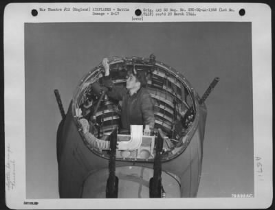 Battle Damage > Charles Novak, Machinist Mate 3Rd Class, Usn, Examines The Remains Of The Bombardier'S 'Greehouse' On A Battle Damaged Boeing B-17 Bomber.  The Plane Made A Forced Landing On A Navy Base At Dunkeswell, Devon, England, Following A Raid Over Germany.  11 Fe