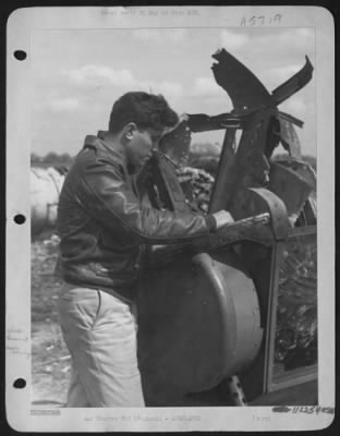 Battle Damage > S/Sgt. Eugene Gaskins Of Jacksonville, Fla., Peers Into Twisted Hulk Of The Nose Turret Of The Consolidated B-24 Liberator "Vadie Raye".  The 20 Year Old Gunner Bailed Out Of The Blazing Aircraft From An Altitude Of 800 Feet After It Had Been Set Afire By