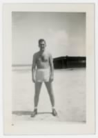 William E. Prettyman in shorts on a beach on the Kwajalein Atoll
