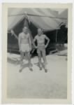 William E. Prettyman and friend in shorts outside a tent on the Kwajalein Atoll