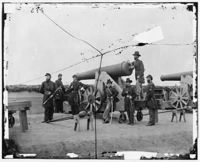 1364 - Washington, D.C., vicinity. Seven officers by a big gun in a fort