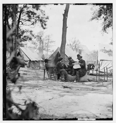 2885 - Gen. Ambrose E. Burnside (reading newspaper) with Mathew B. Brady (nearest tree) at Army of the Potomac headquarters
