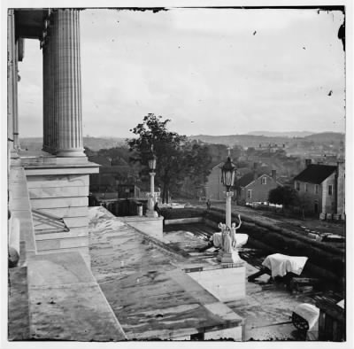 3632 - Nashville, Tenn. Steps of the Capitol with covered guns; vista of the city beyond