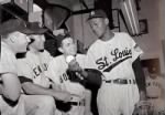 Leroy "Satchel" Paige shows grip to Mantle, Reynolds, Dimaggio